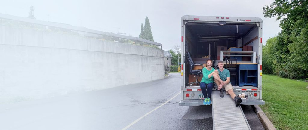 Couple sitting in Book A Move Truck